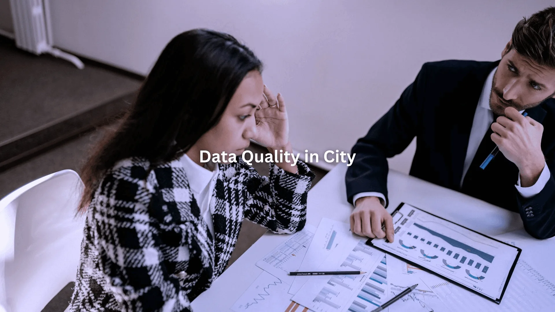 Two professionals reviewing charts and data, discussing data appending services city for business growth.