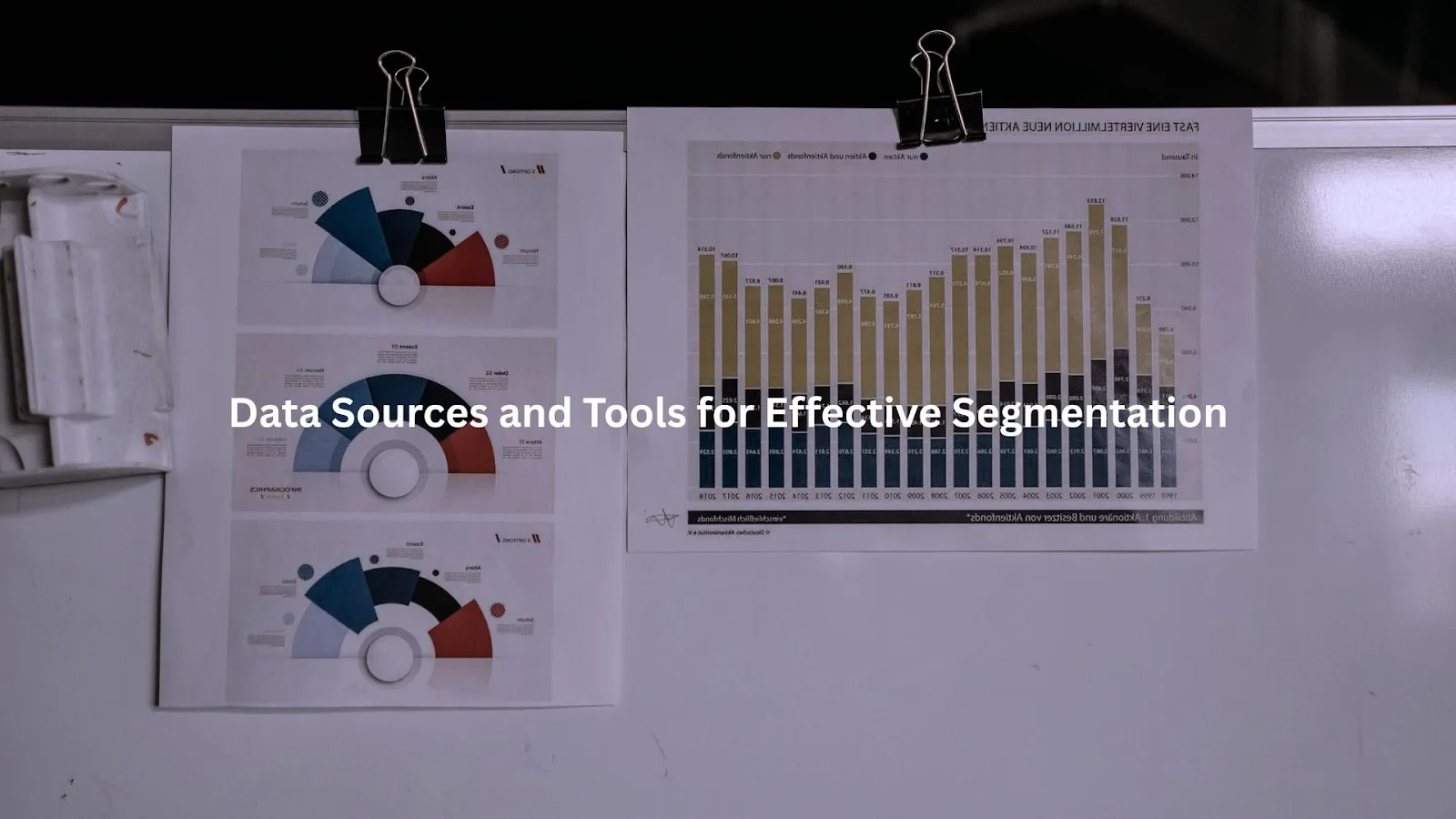 Colorful data visualizations and charts on a cluttered desk, highlighting data sources and tools for effective segmentation.
