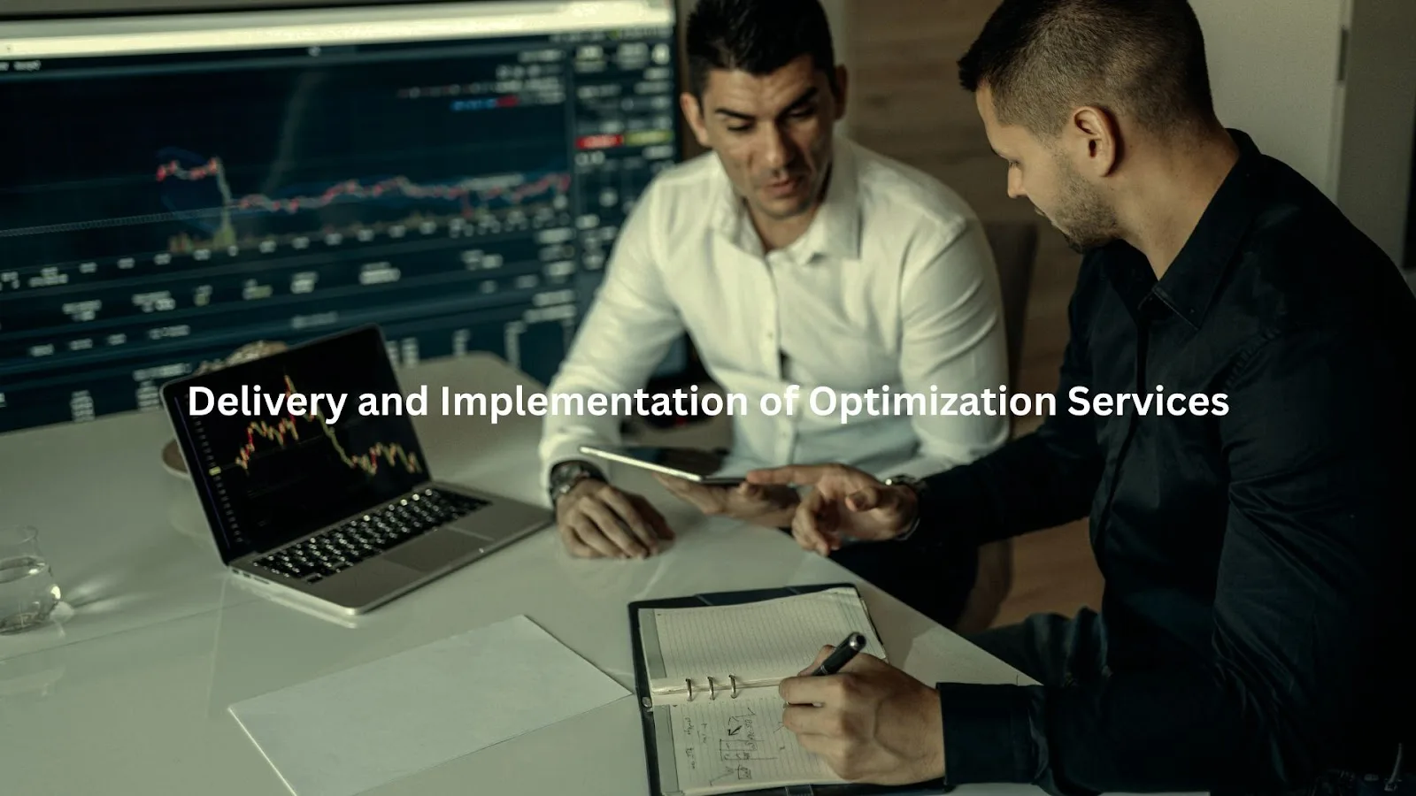 Business professionals discussing B2B sales funnel optimization services on laptops in an office setting.